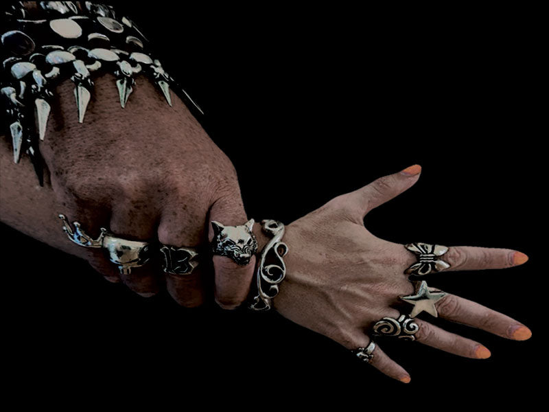 chunky silver jewellery on a man's hand and a woman's hand